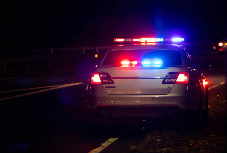 Police Car with Lights On at Night